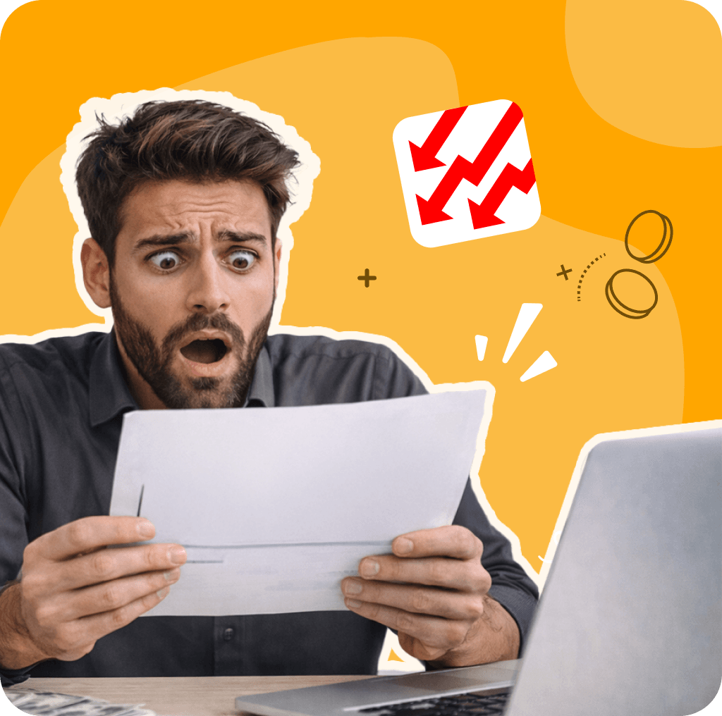 Shocked man reading a report next to a laptop